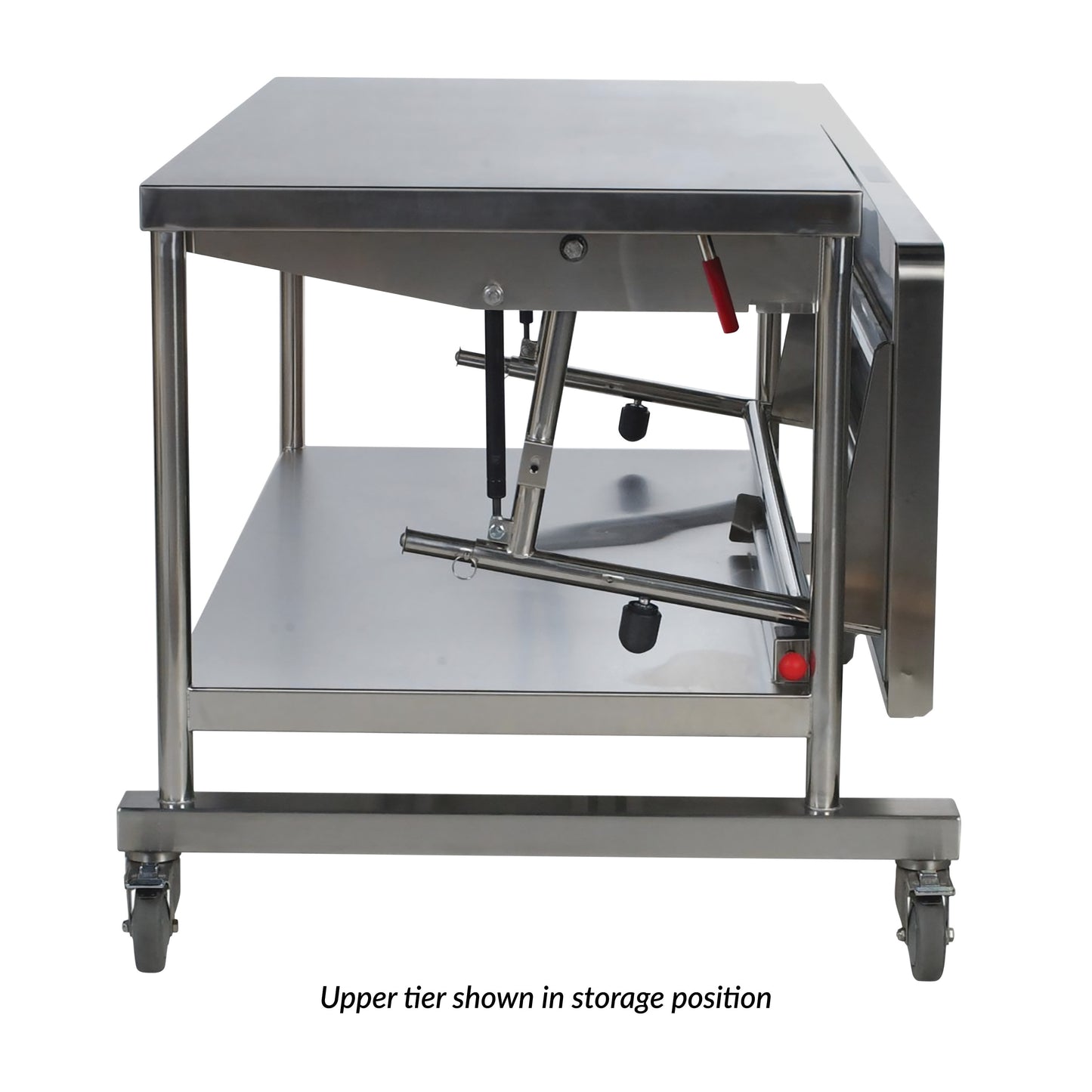 The Pedigo Space Station, a stainless steel medical cart with a collapsible upper tier, on wheels, shown in storage position.