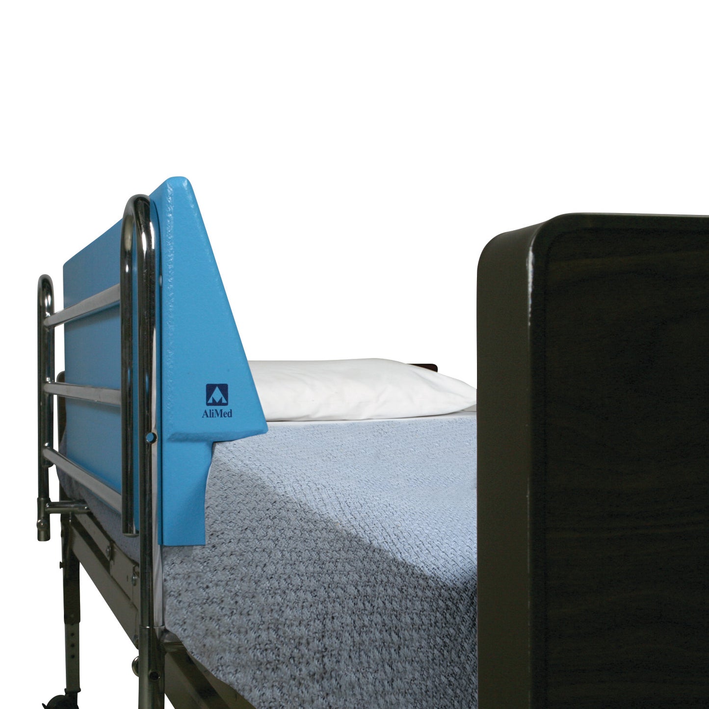 A hospital bed with a blue AliMed Antimicrobial Waterproof Foam Bed Bolster, metal side rails, and a light blue blanket.