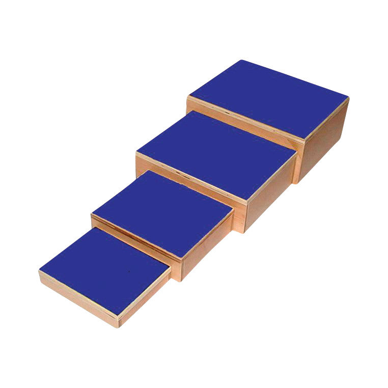 Four Nested Footstool pieces with blue tops are aligned in decreasing size, resembling stair steps.