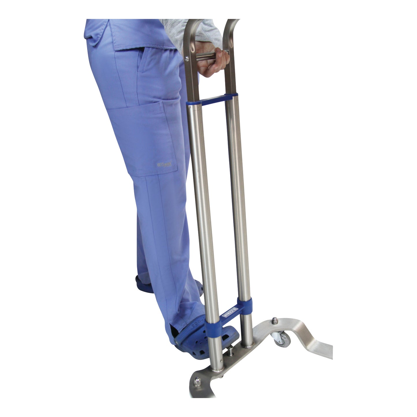 A person in blue scrubs positioned on a Blickman Benjamin Mayo Stand with one foot in a holder, gripping the metal frame for support.