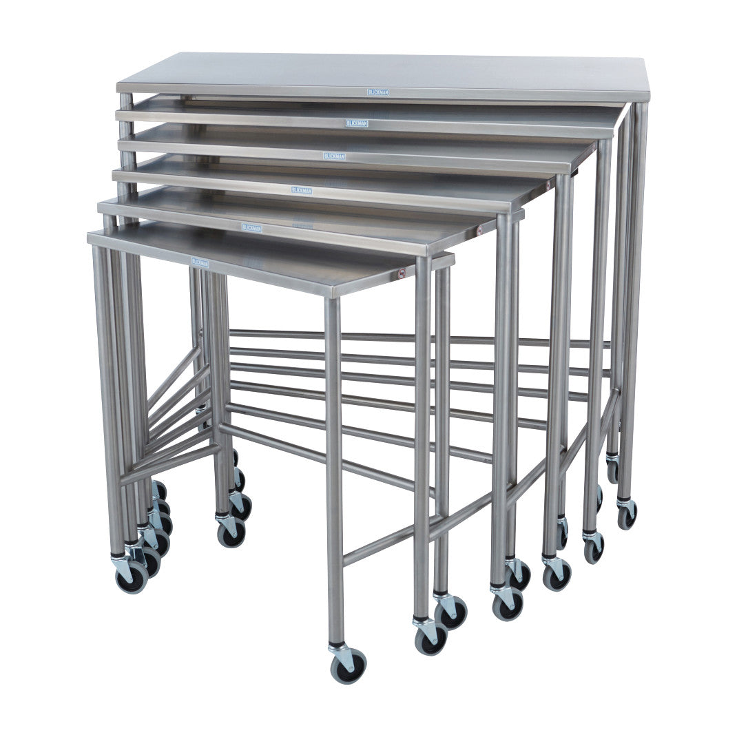 Six stainless steel Blickman Nested Instrument Tables are stacked, showing various sizes, each on wheels for mobility.