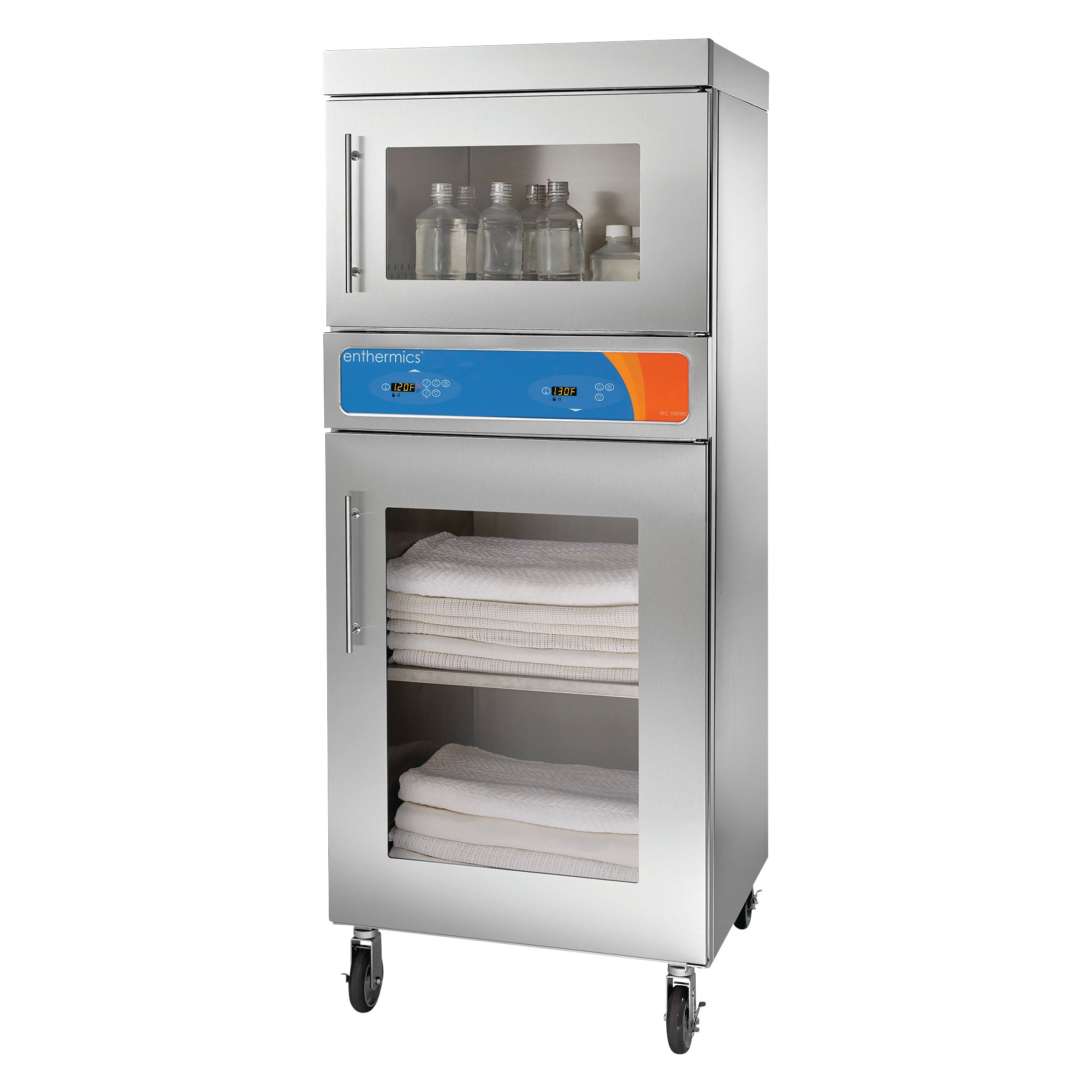 Pedigo Enthermics Combination Blanket and Fluid Warming Cabinet with stainless steel finish, displaying stacked towels and bottles inside.