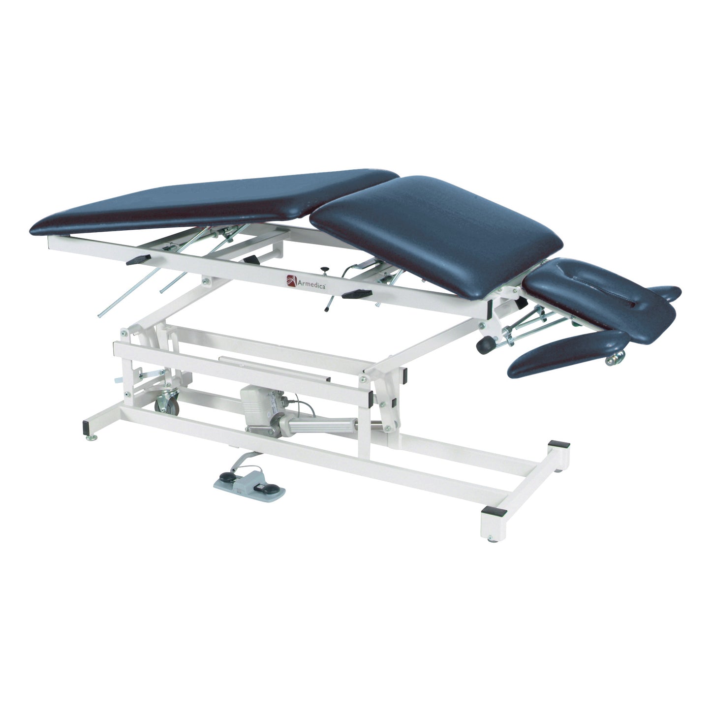 Armedica AM-500 Treatment Table with adjustable padded sections, white metal frame, and a foot lever for height adjustment.