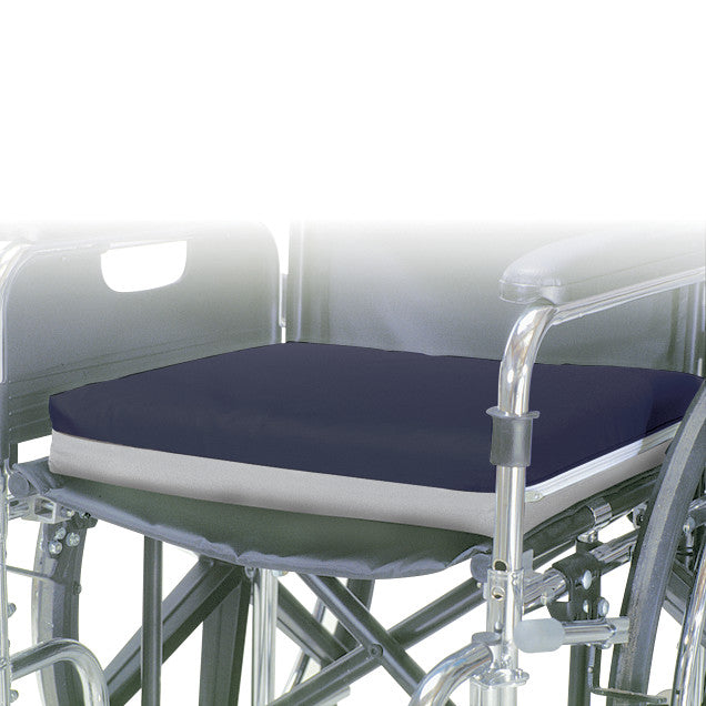 A navy blue AliMed Super-Economy Gel Wheelchair Cushion is placed on a wheelchair, providing comfort and support.