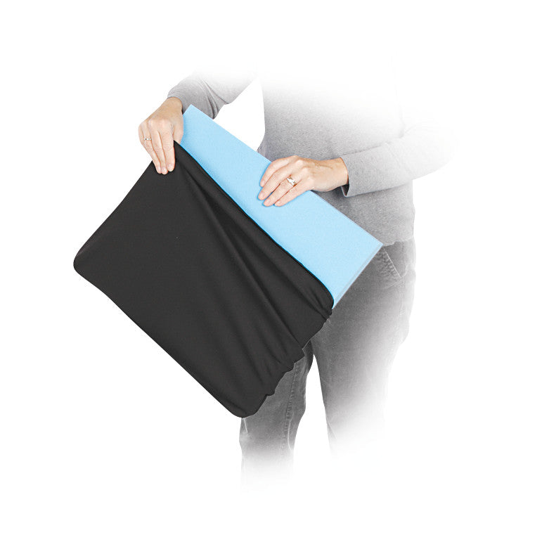 A person holds an AliMed Replacement Wheelchair Cushion Cover with a blue foam cushion partially inserted.