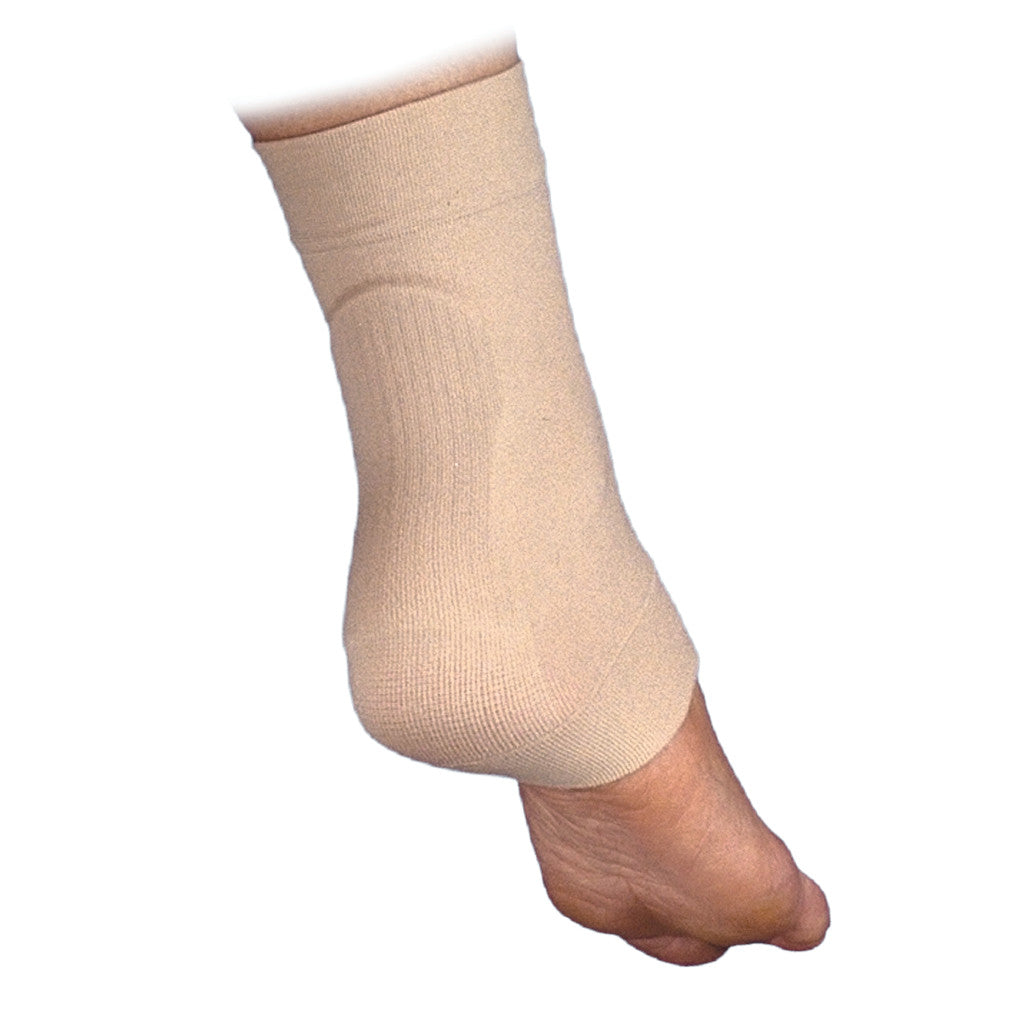 A foot wearing a beige Silopad Achilles Heel Pad, designed for providing cushioning and support to the heel and ankle area.