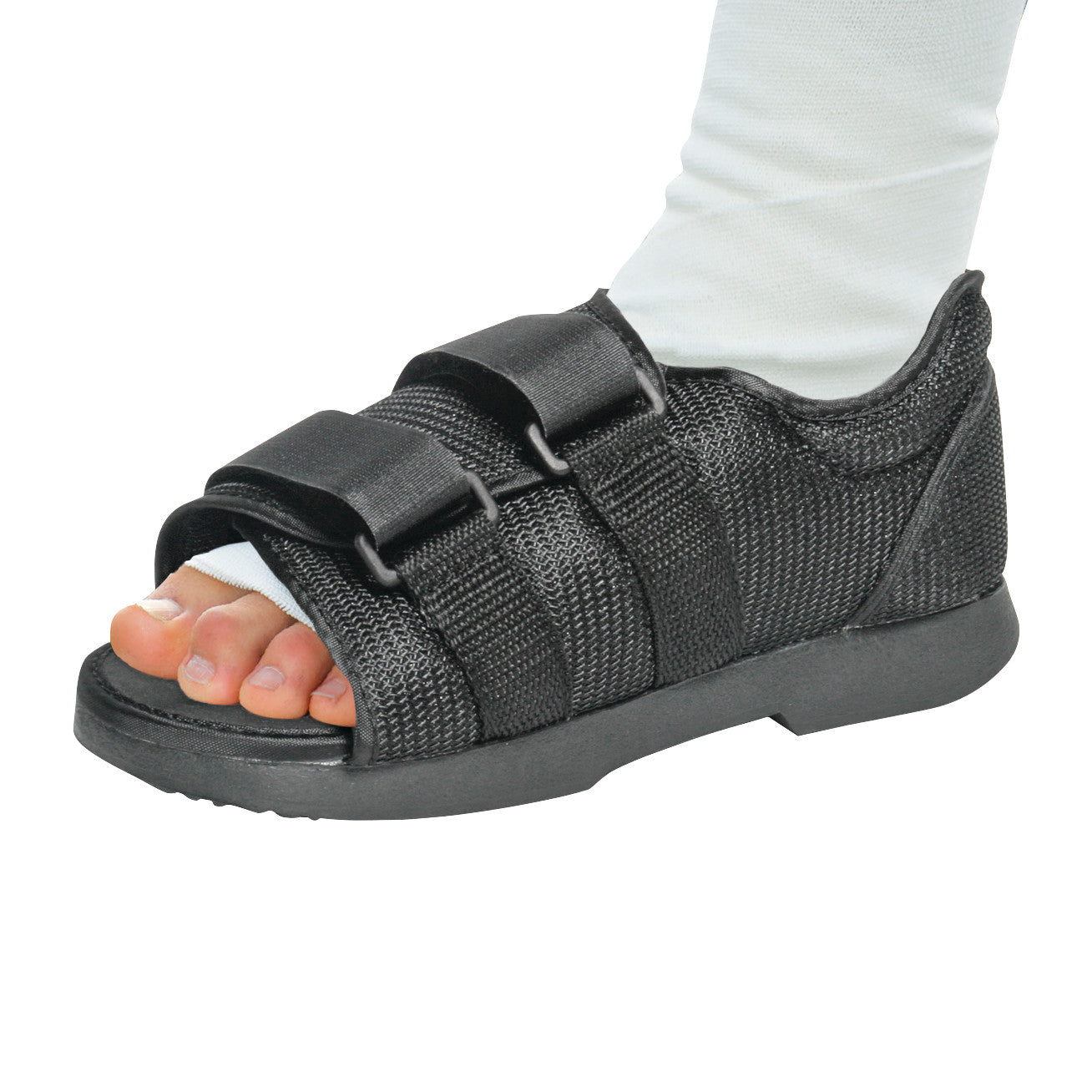 A foot wearing an AliMed Classic Post-Op Shoe with black mesh and adjustable straps, exposing the toes for comfort and support.