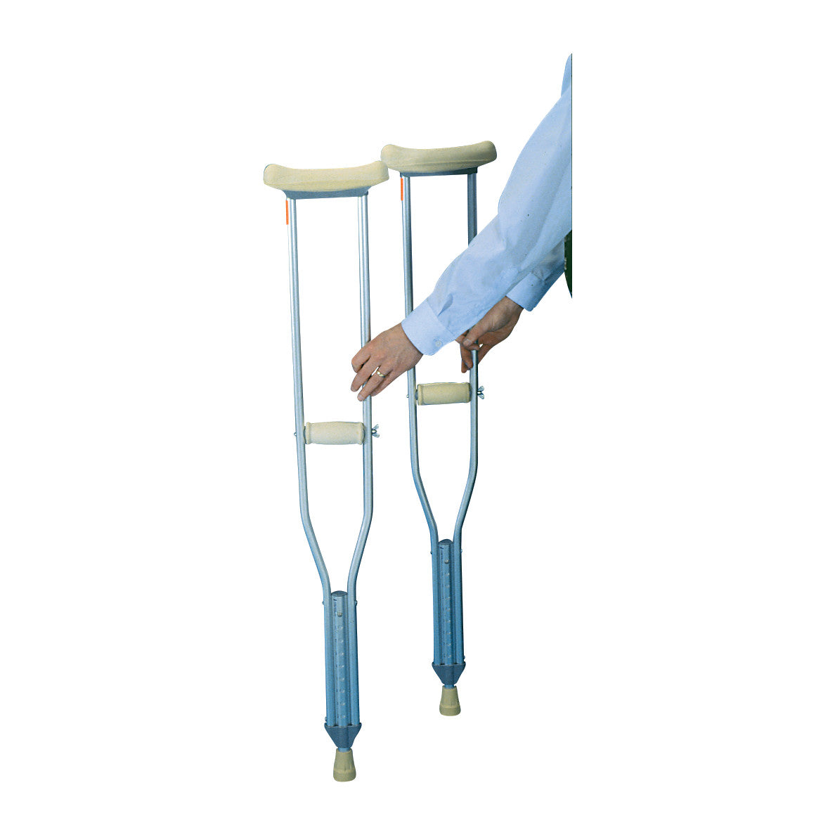 A person adjusts a pair of Drive Medical Axillary Crutches, featuring padded underarm supports and hand grips on metal frames.
