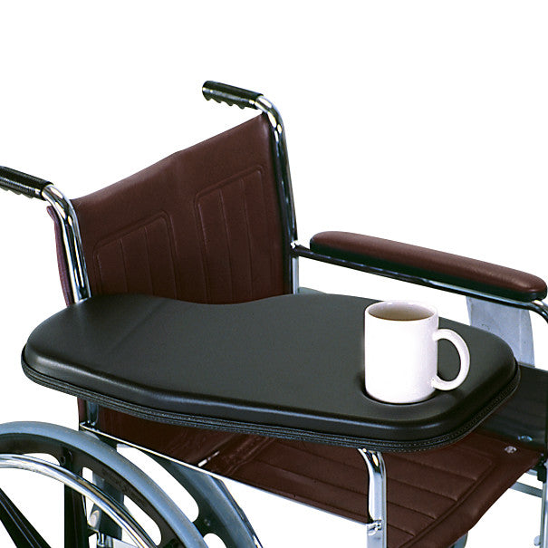 A wheelchair equipped with a Therafin Padded Flip-Away Arm Support and a white mug placed on the armrest.