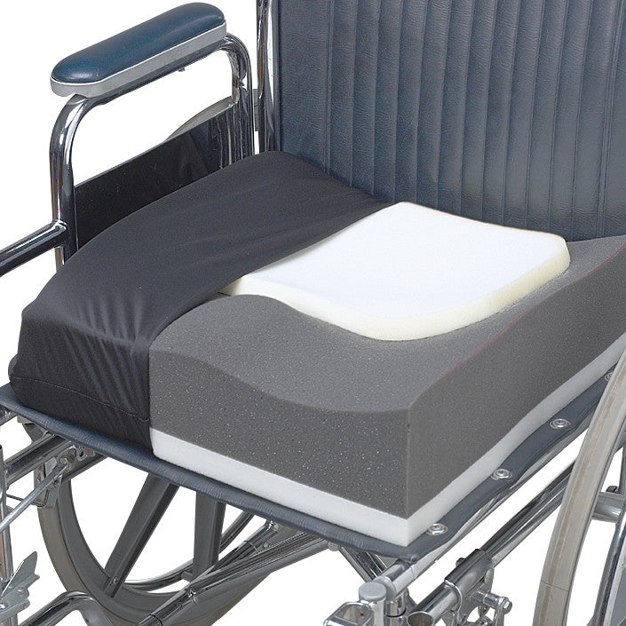 The SkiL-Care Contour Wheelchair Cushion features layered foam with a cutout design on a wheelchair seat for added comfort.