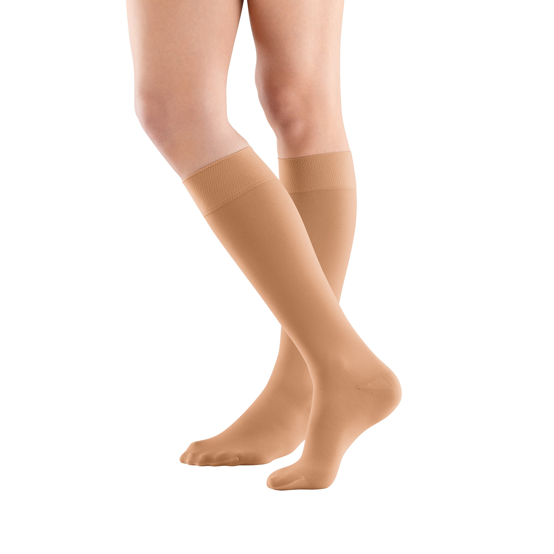 Legs wearing Bauerfeind VenoTrain micro AD Closed Toe Compression Stockings in a beige color, extending up to the knee.