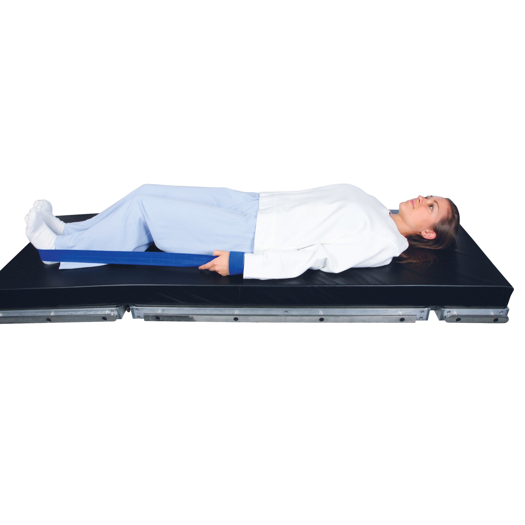 A person uses the AliMed Auto Traction Strap while lying on a black medical mat, demonstrating its application for leg support.