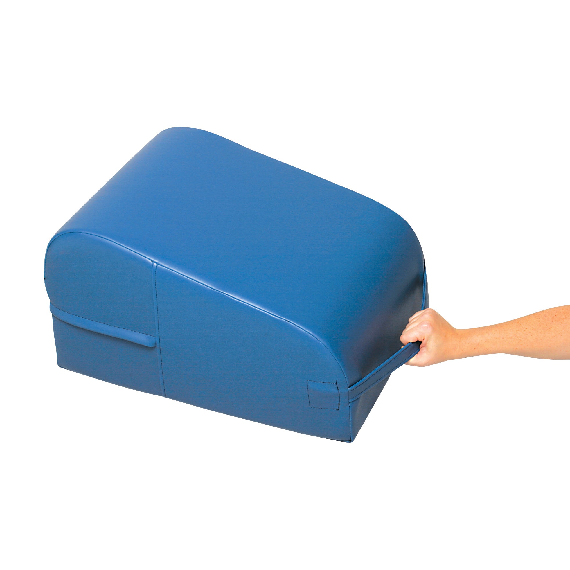 A hand holds the strap of an AliMed Lower Extremity Wedge, a blue foam wedge used for leg elevation and support.