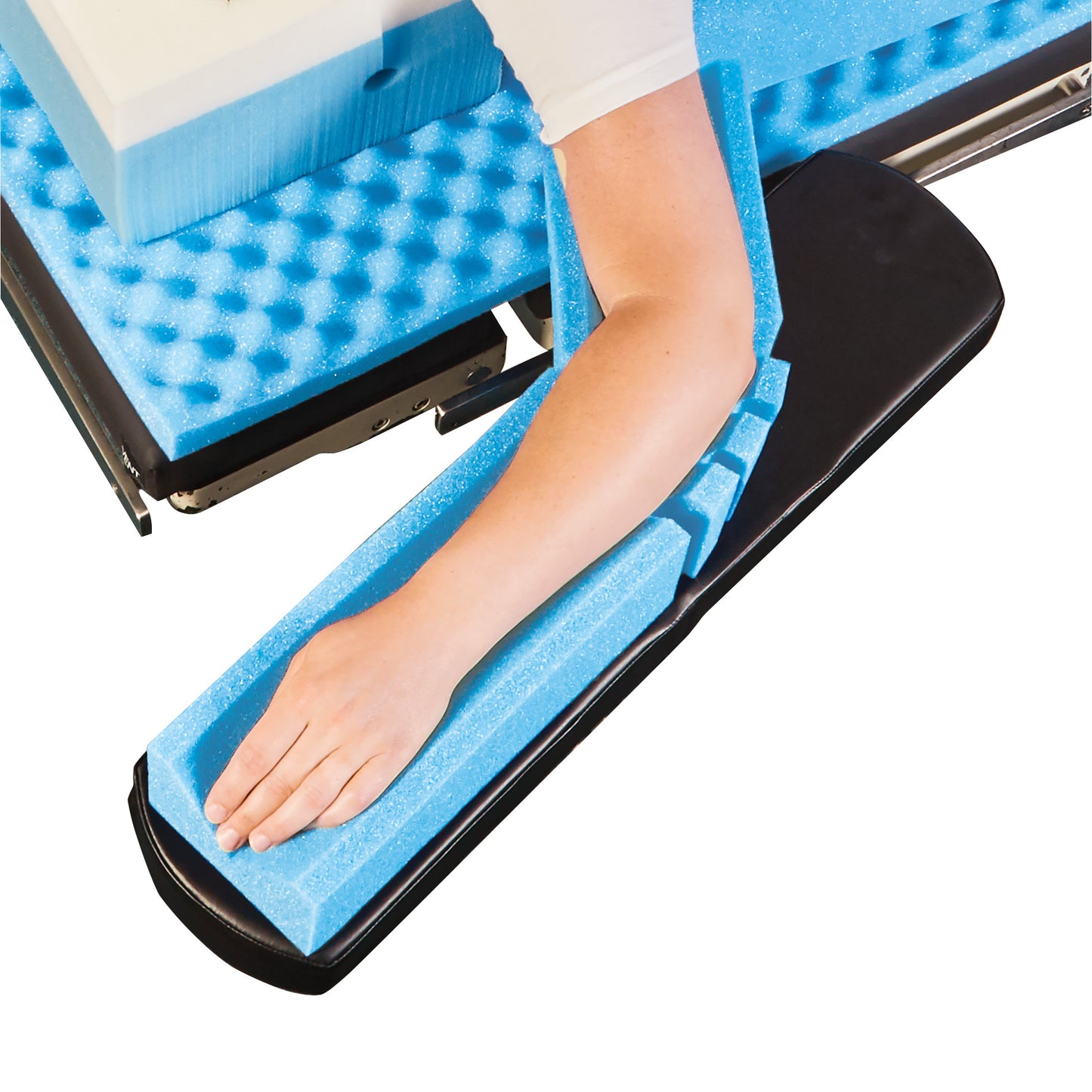 An arm rests in a blue foam AliMed Arm Cradle, providing support and cushioning, shown on a flat surface.