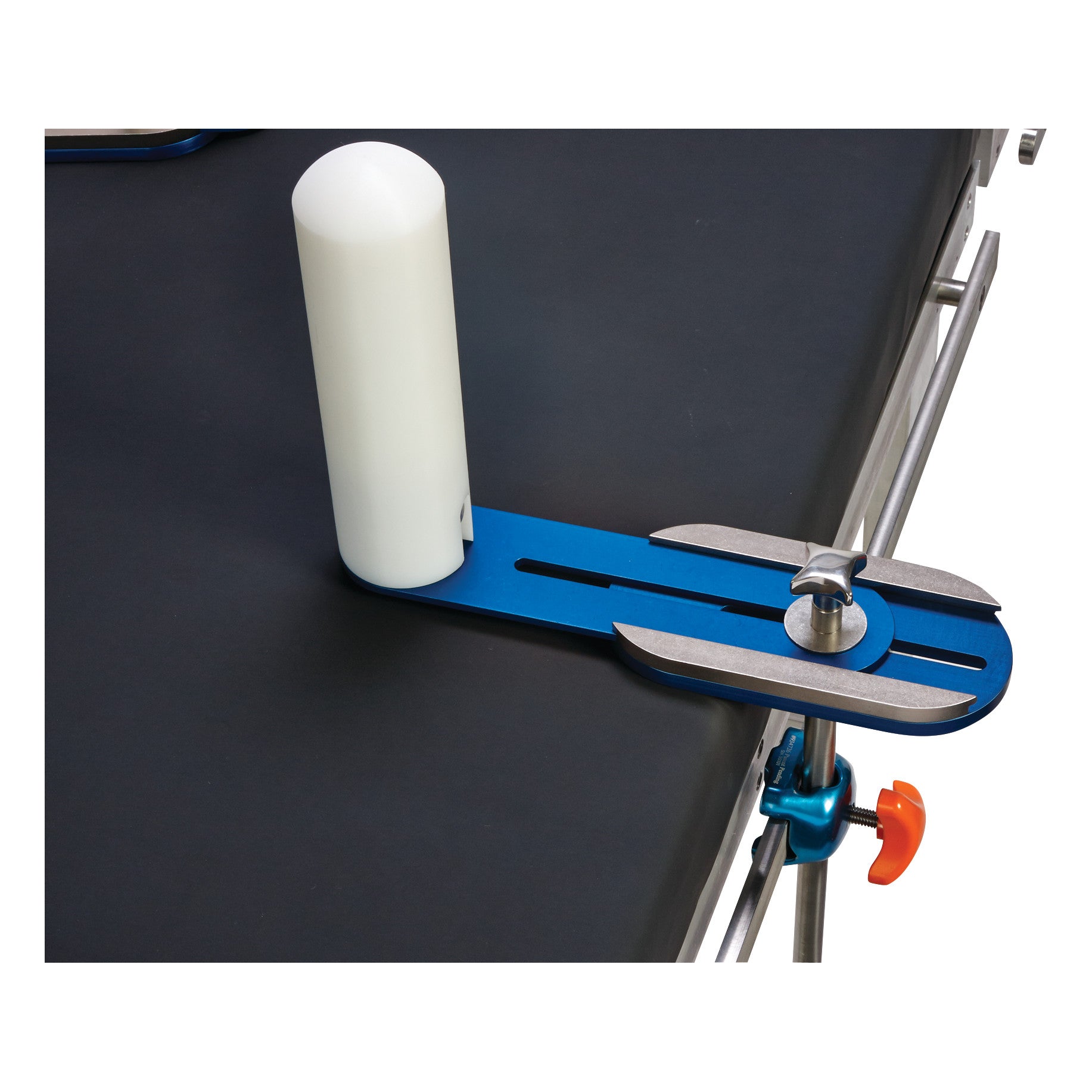 AliMed Anterior Lateral Positioner attached to a table, featuring a blue base, white cylindrical pad, and adjustable clamps.