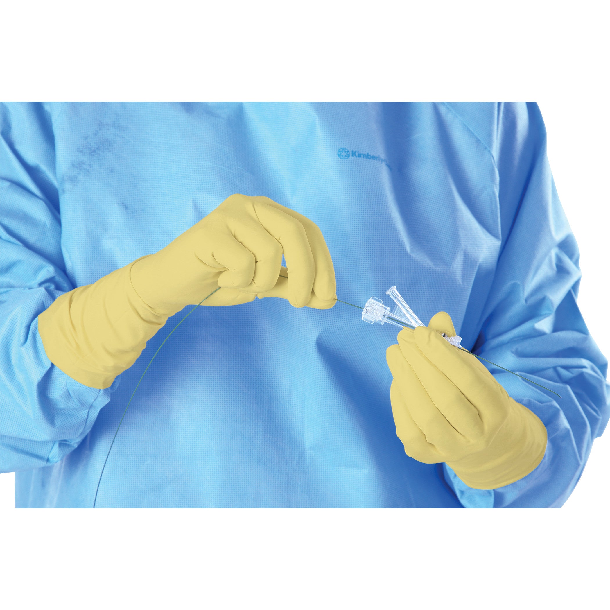 A person wearing AliMed Original Radiation Attenuation Gloves and a blue gown holds medical tubing and connectors.