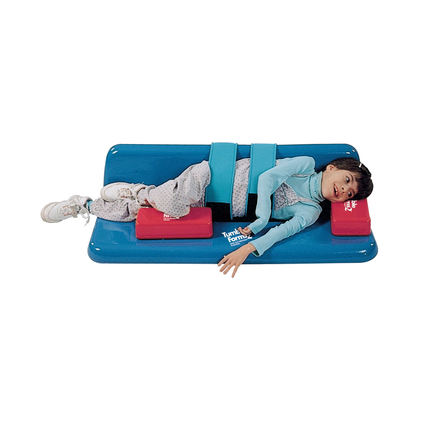 A child lies on a Tumble Forms2 Universal Sidelyer Positioner, secured with straps, and supported by red foam cushions.