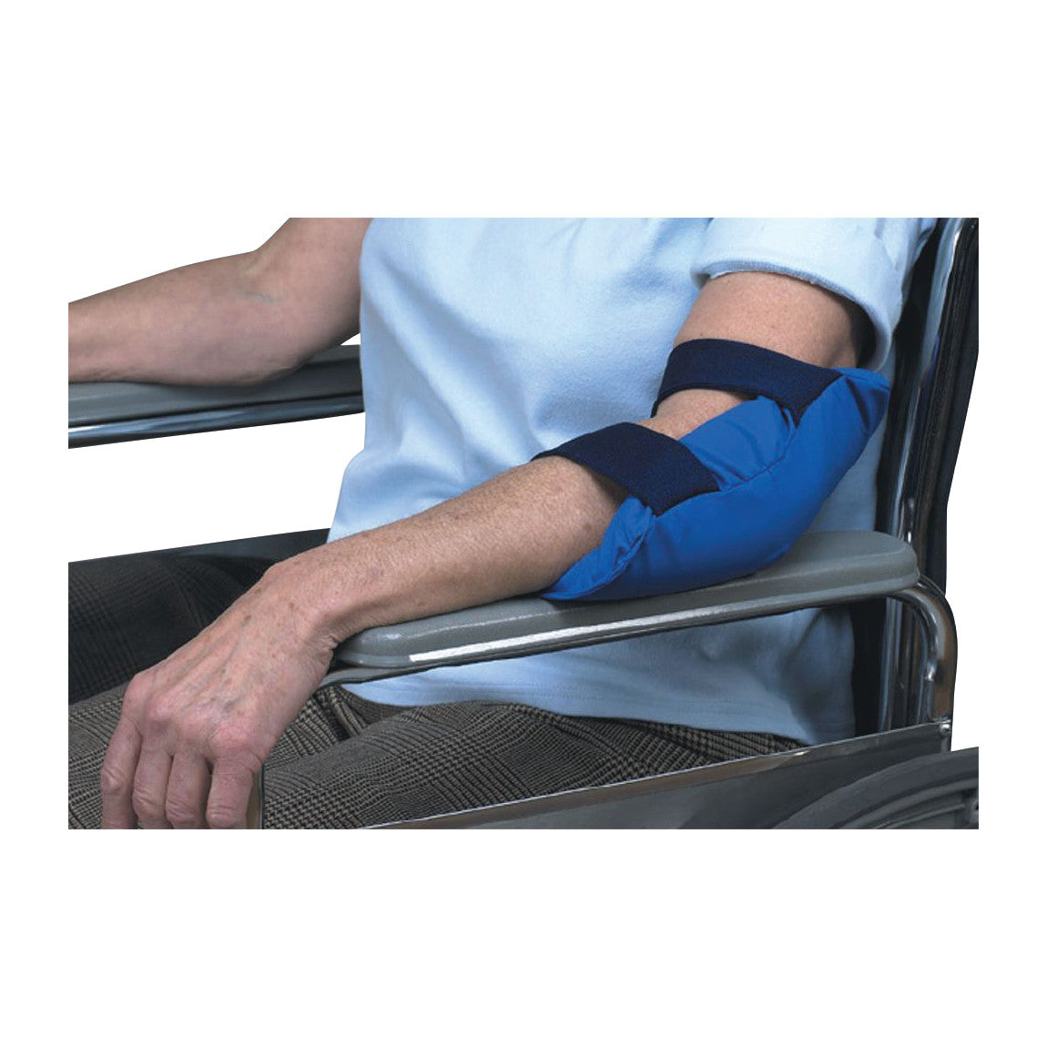 A person in a wheelchair uses a SkiL-Care Visco-Foam Elbow Pad. The blue pad is secured around the arm with straps.