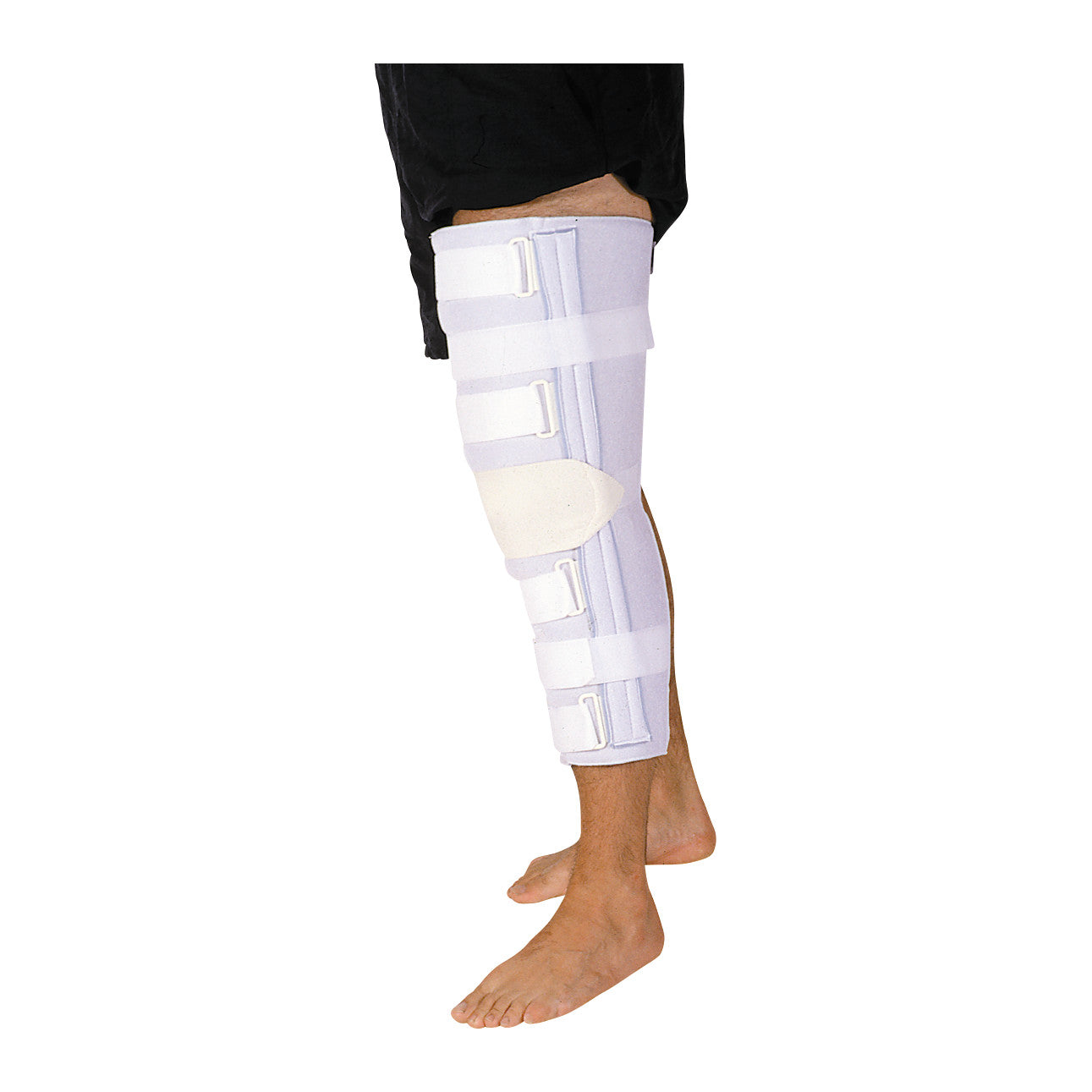 A person wearing a Universal Knee Immobilizer on their right leg, featuring white straps and padding, standing barefoot.