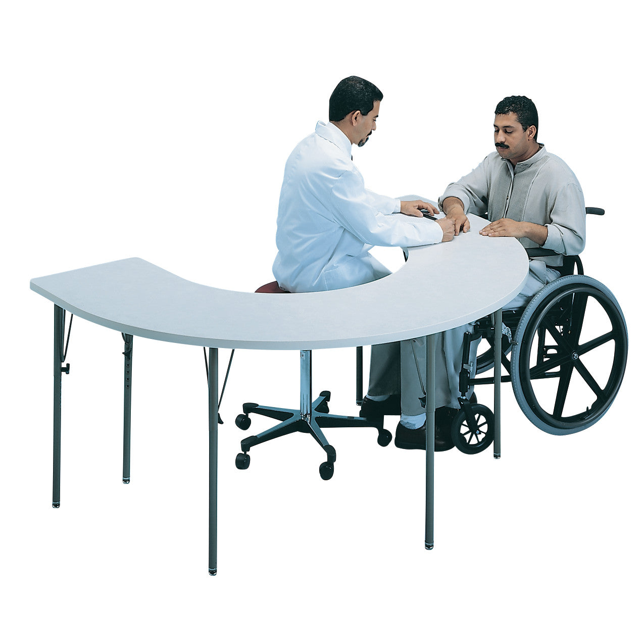 A therapist works with a patient in a wheelchair at a Horseshoe Therapy Table, designed for accessibility and interaction.