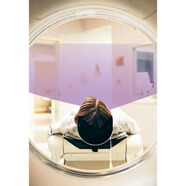 A person is lying down wearing AliMed Deluxe Prism Glasses, visible through a circular opening, likely during a medical procedure.