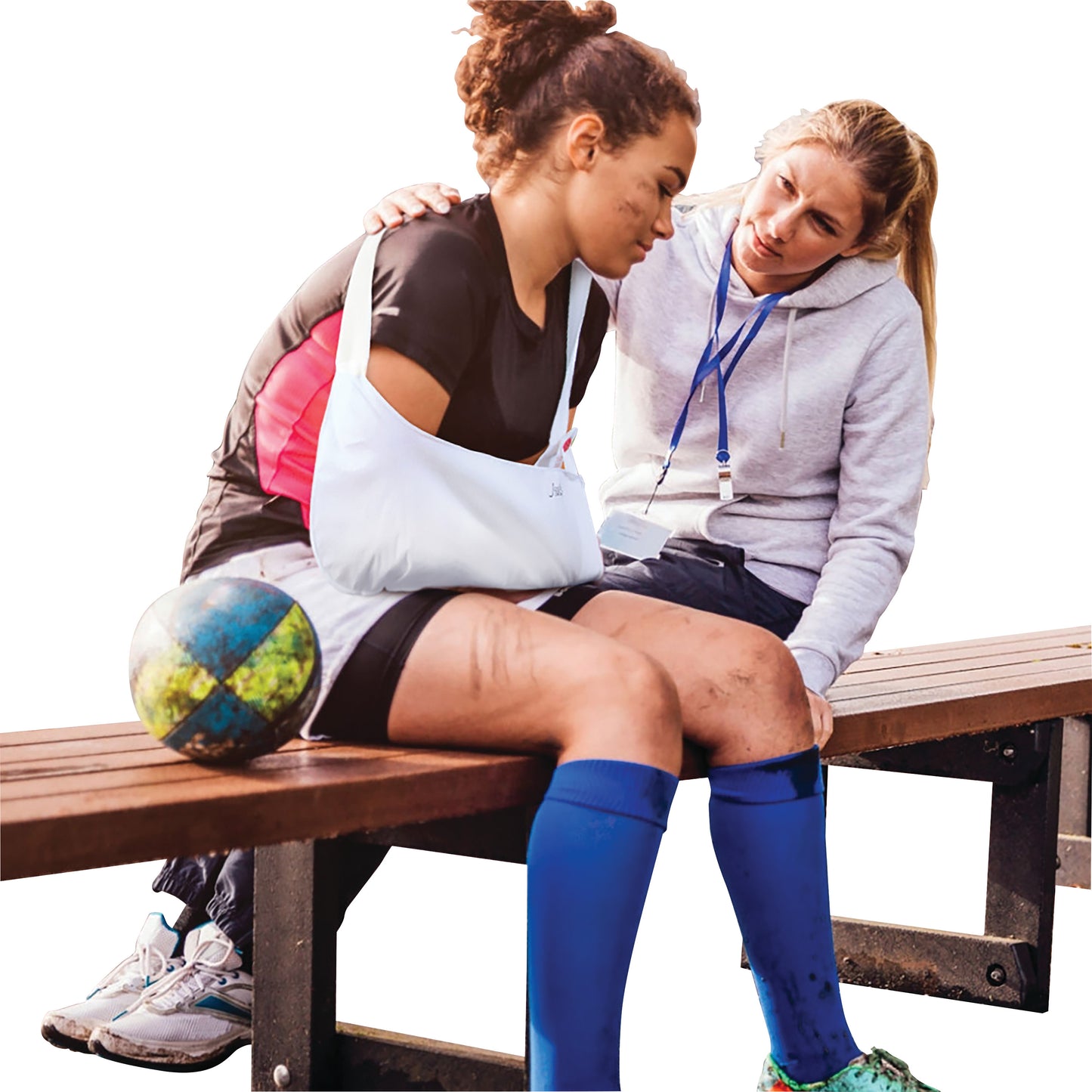 A woman wearing a Brownmed Joslin ER Sling sits on a bench beside a concerned person. A sports ball is nearby.