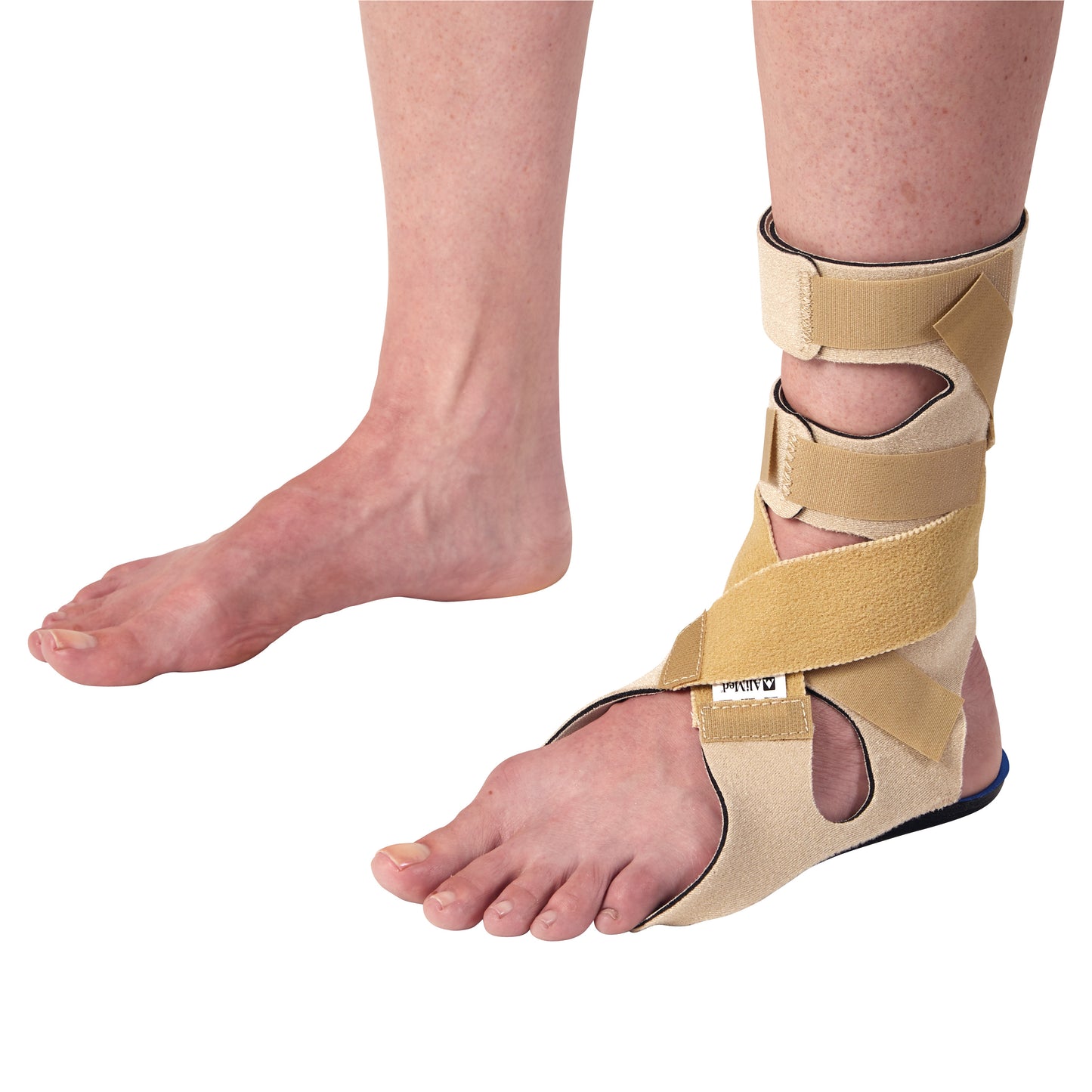A person wears the AliMed FREEDOM Soft Footdrop Brace on one foot for support. The other foot is bare, showing a contrast.
