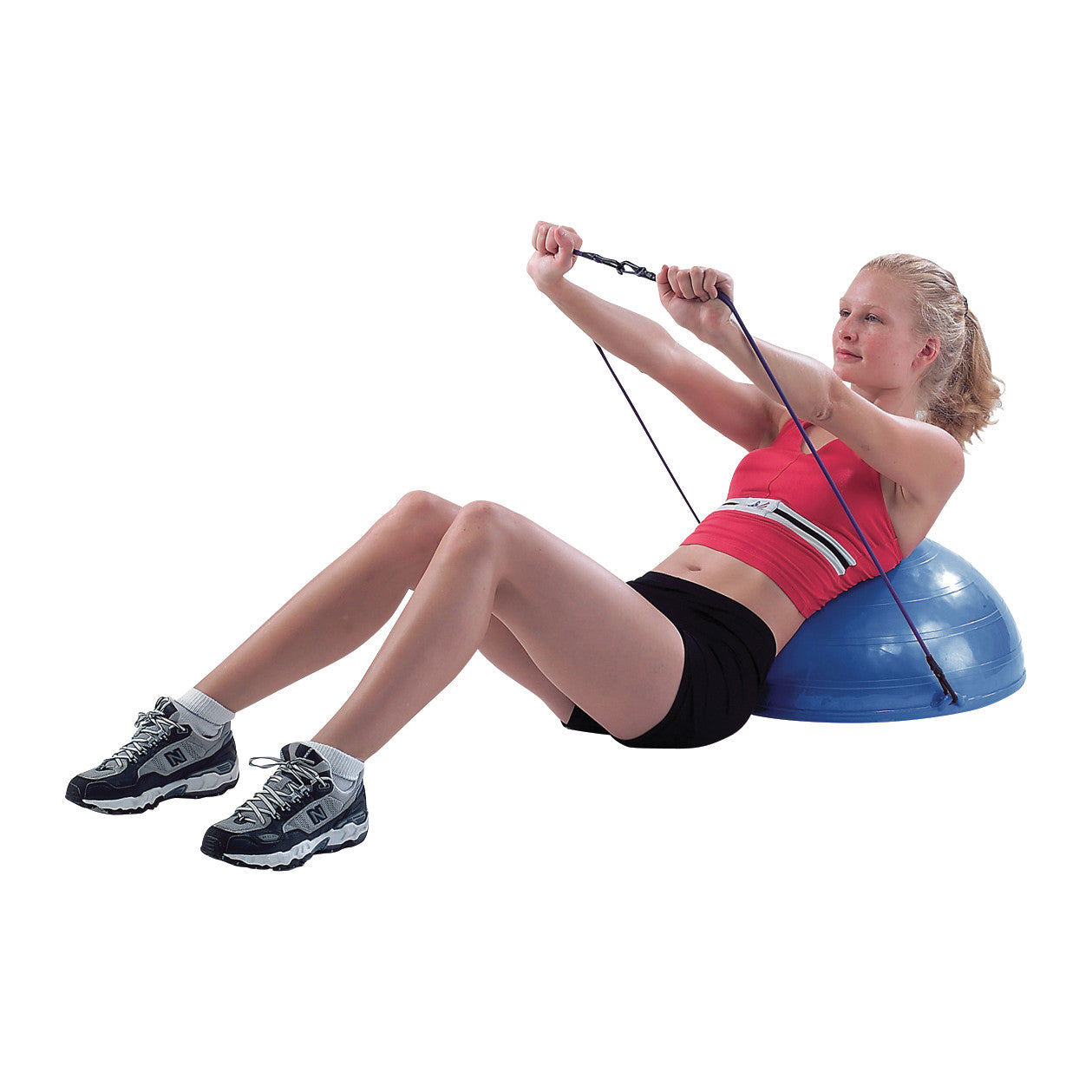 A person exercises with a CanDo Core-Training Dome, using resistance bands. They're wearing athletic gear and sitting on the dome.