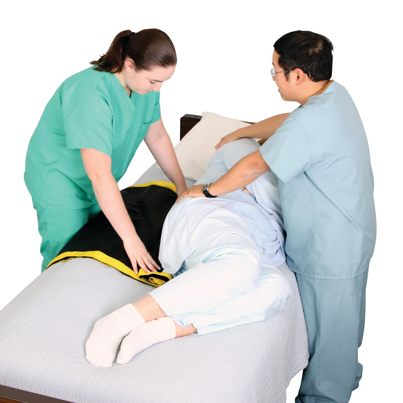 Two healthcare workers use the AliMed No-Lift TURNER to assist a patient in turning on a bed.