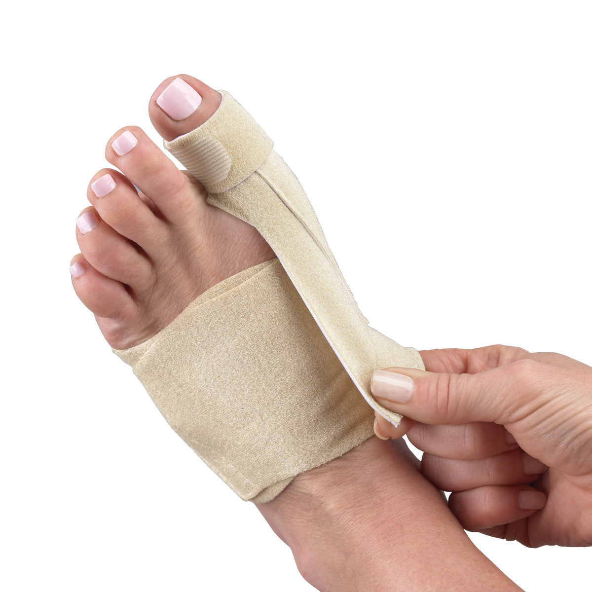 A foot wearing a 3pp Bunion-Aider, a beige fabric brace, with a strap being adjusted around the big toe.