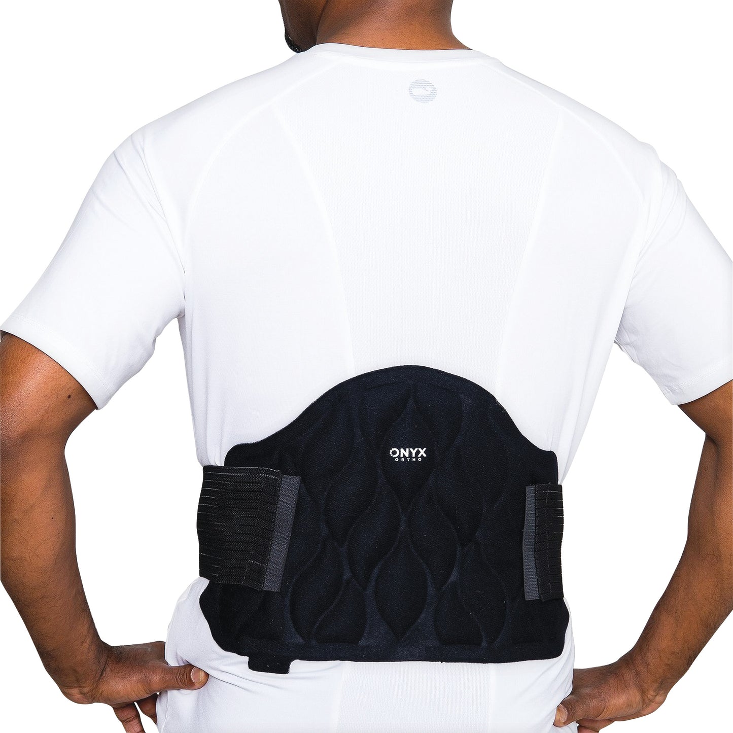 A person wearing the Xena Therapies Onyx Cool Back/Hip wrap in black over a white shirt.
