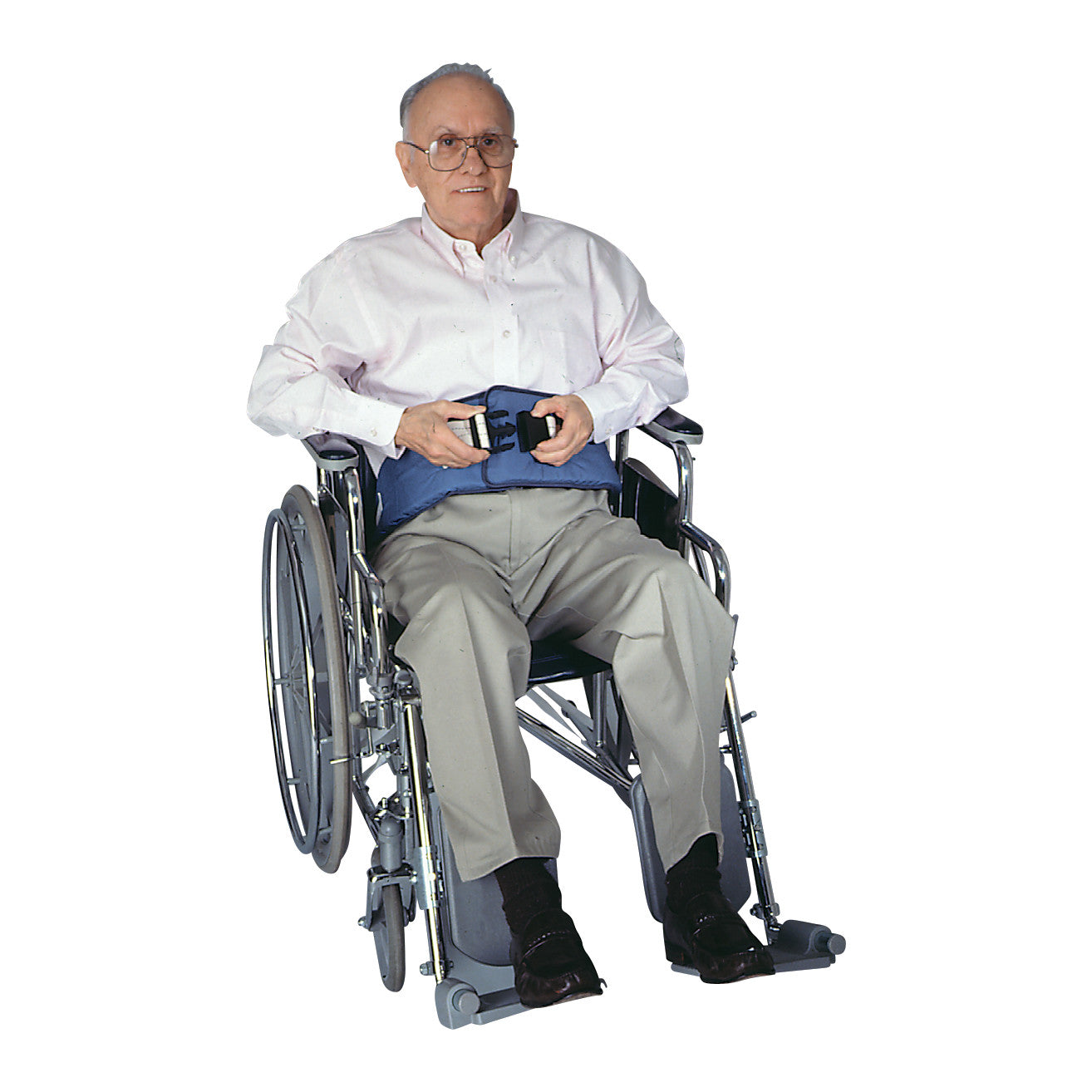 An elderly man sits in a wheelchair wearing the SkiL-Care Resident-Release Soft Wheelchair Belt, which is secured at the waist.