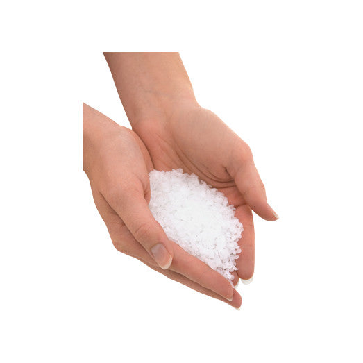 Hands holding white granules of Therabath Paraffin Bath Beads Refill on a white background.