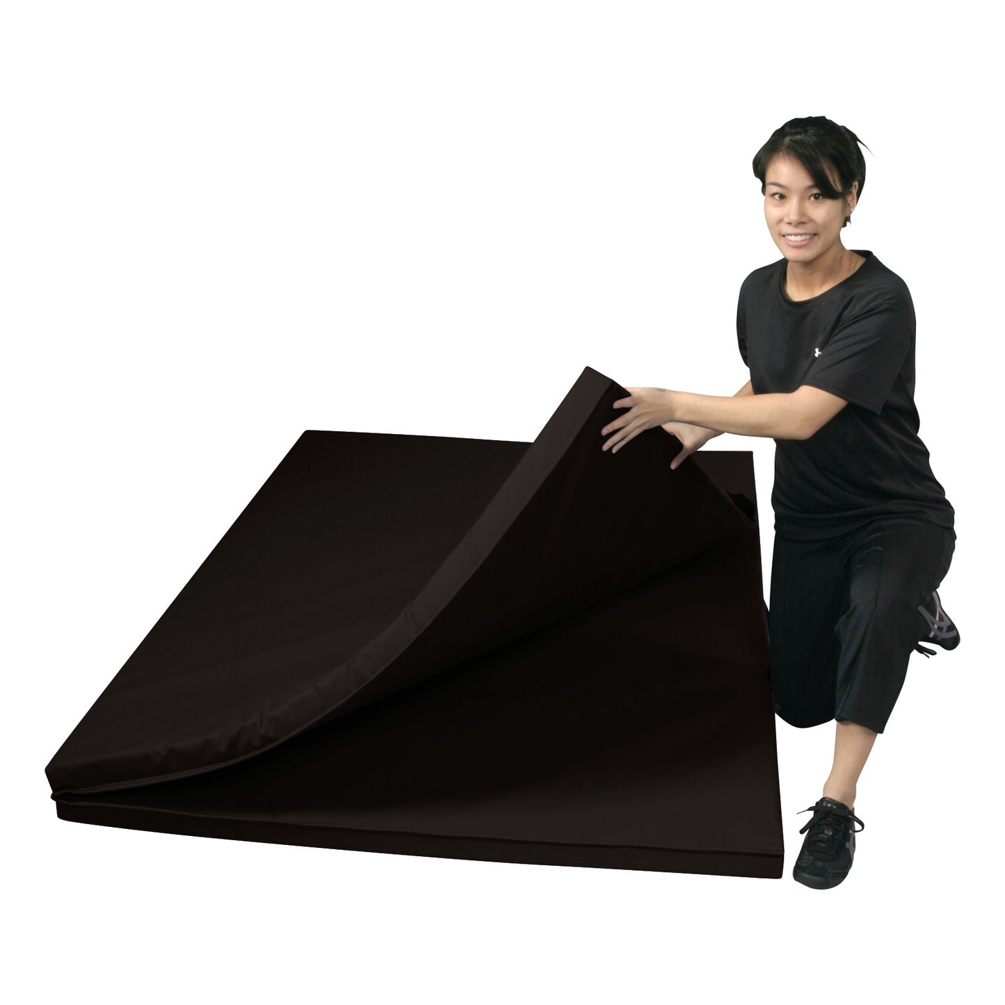 A person kneels next to an AliMed Universal Folding Mat, lifting one corner, showing its foldable design.