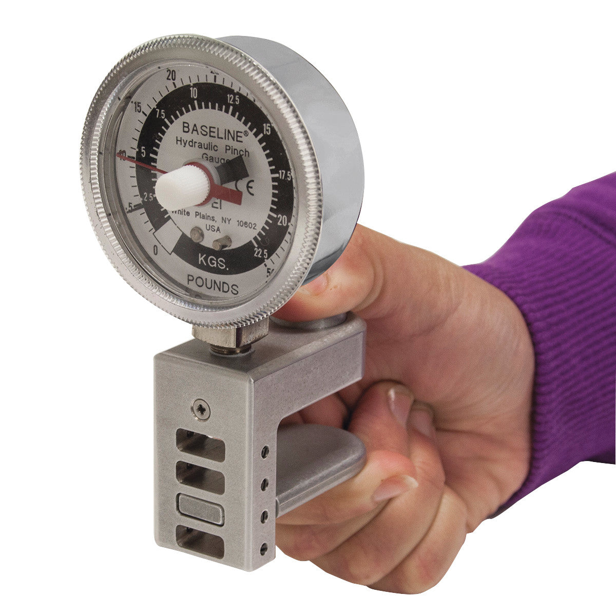 A person holds the Baseline Hydraulic 5-Level Pinch Gauge Clinical Model, measuring hand strength in kilograms and pounds.
