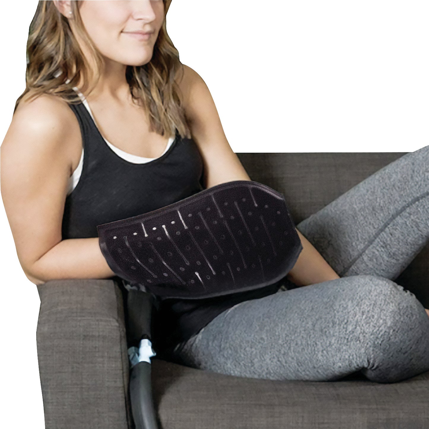 A woman uses the Mitt for Pain Management Technologies Hot/Cold Therapy Aqua Relief System, sitting on a couch.