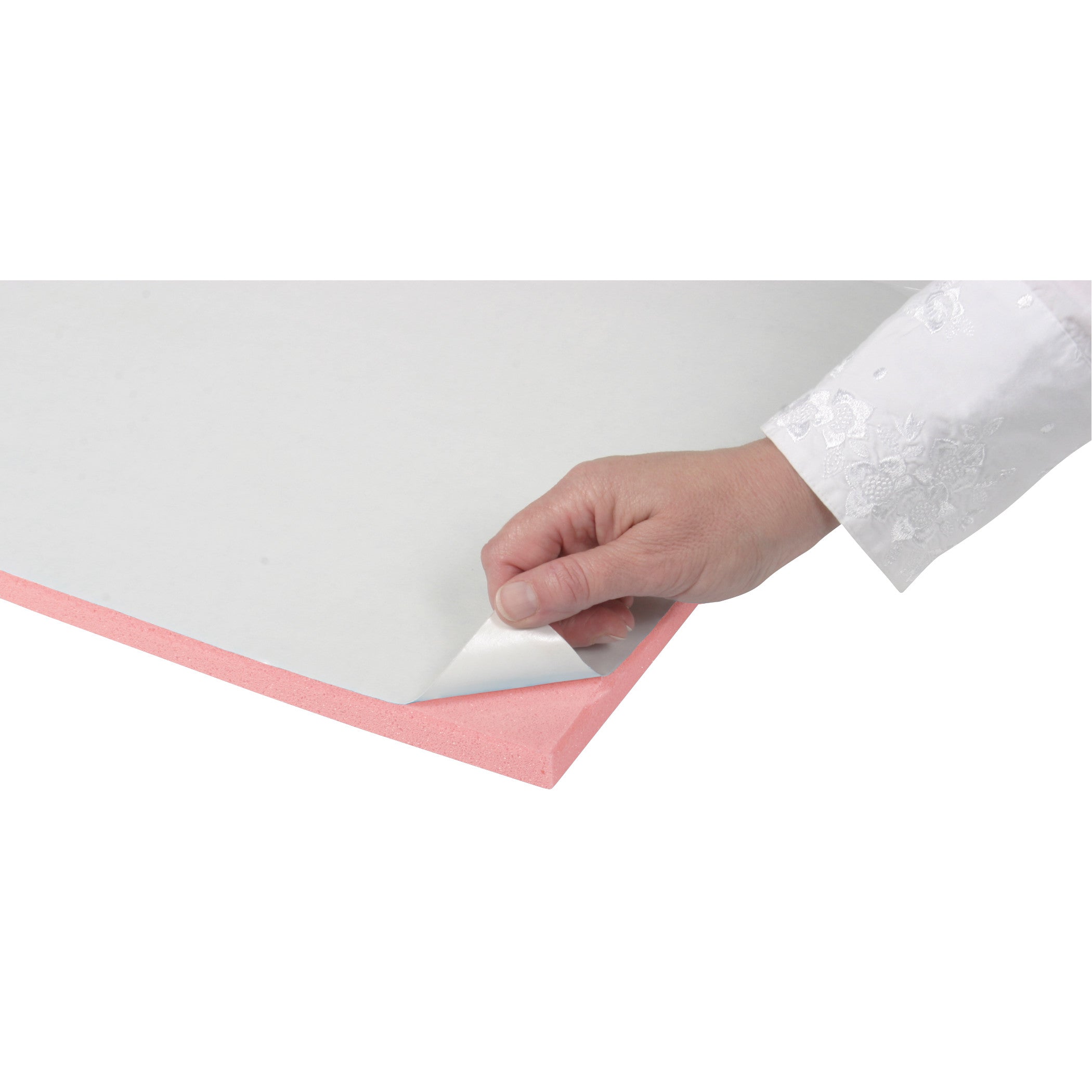 A hand peels the backing off AliMed T-Stick Adhesive-Backed Padding, which is pink with a white adhesive layer.