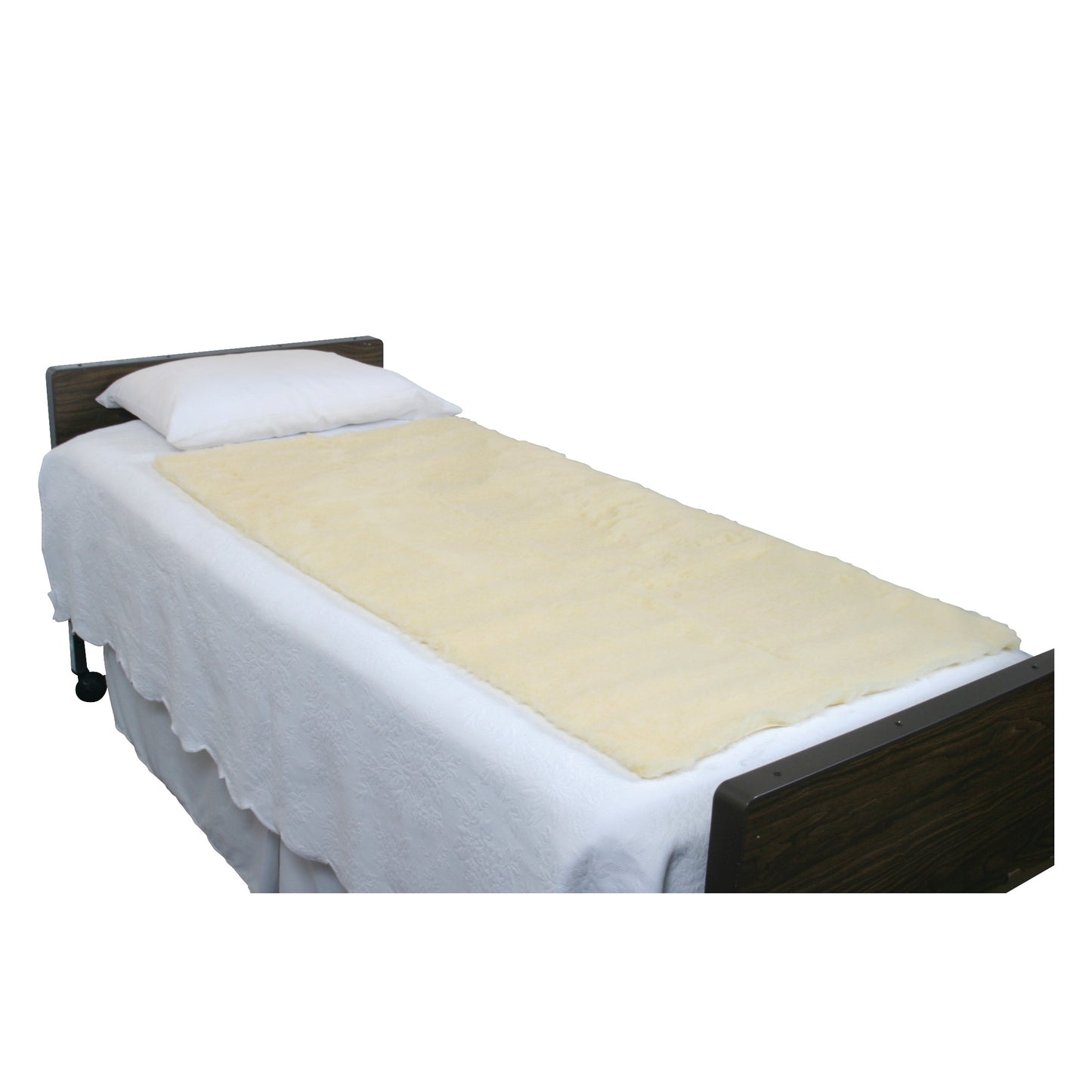 A single hospital bed features a white sheet, pillow, and a SkiL-Care Synthetic Sheepskin Pad on the mattress.