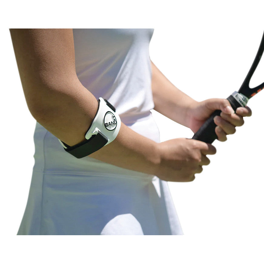 A person wearing a BandIT elbow brace while holding a tennis racket. The BandIT is black and white and wraps around the forearm.
