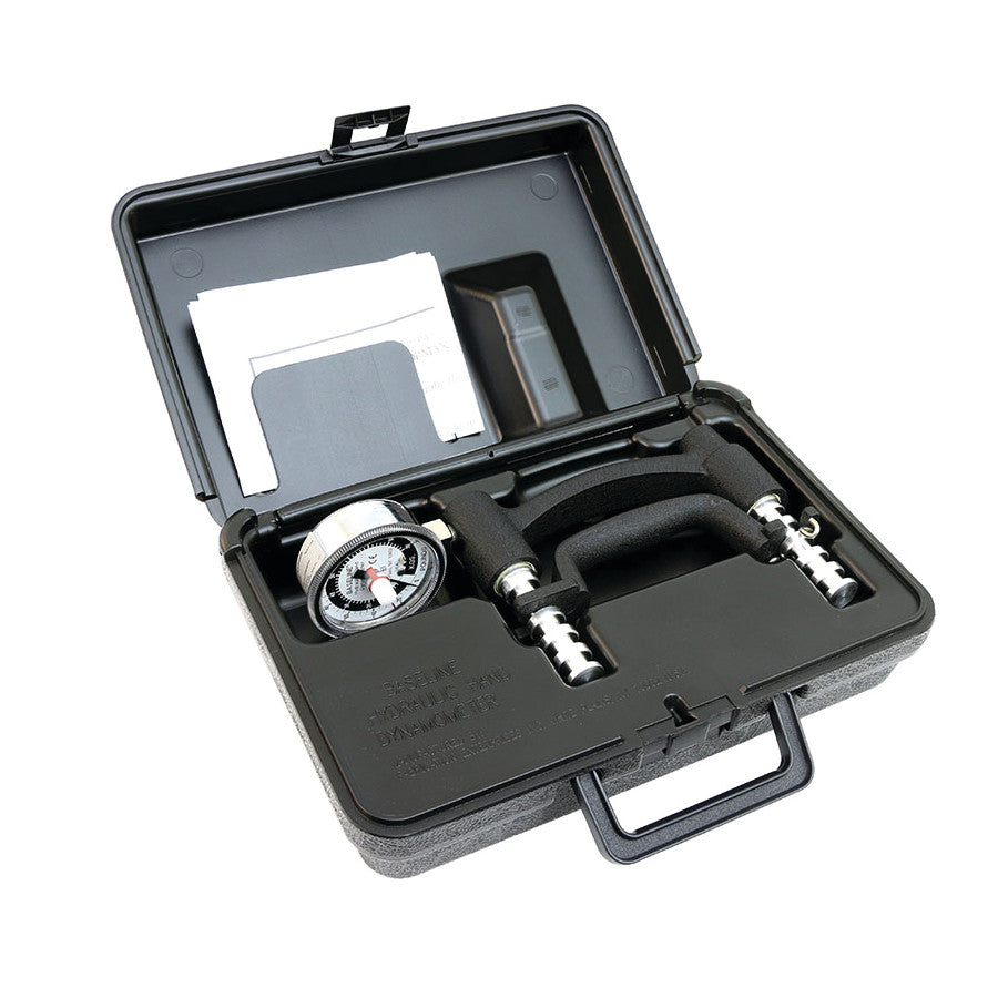 Open black case containing a Baseline Hand Dynamometer HD with gauge, handle, and papers.
