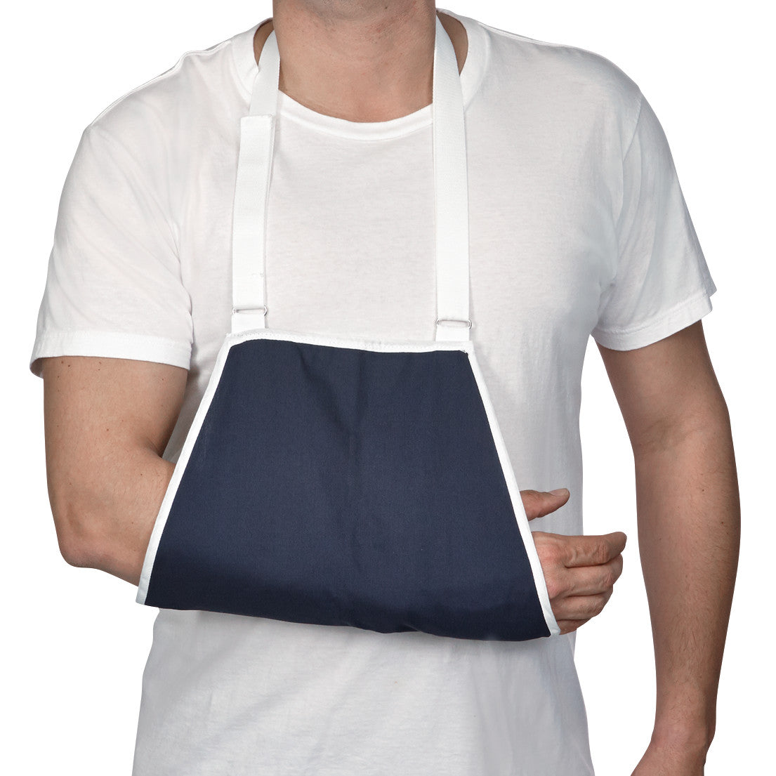 A person wears an AliMed Open End Arm Sling in blue with white straps. The arm is supported across the chest.