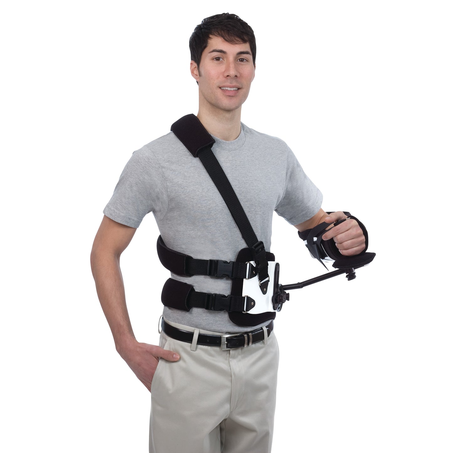 A person wearing the Trulife Gunslinger II, a black upper body brace with shoulder and torso straps, and an arm support.