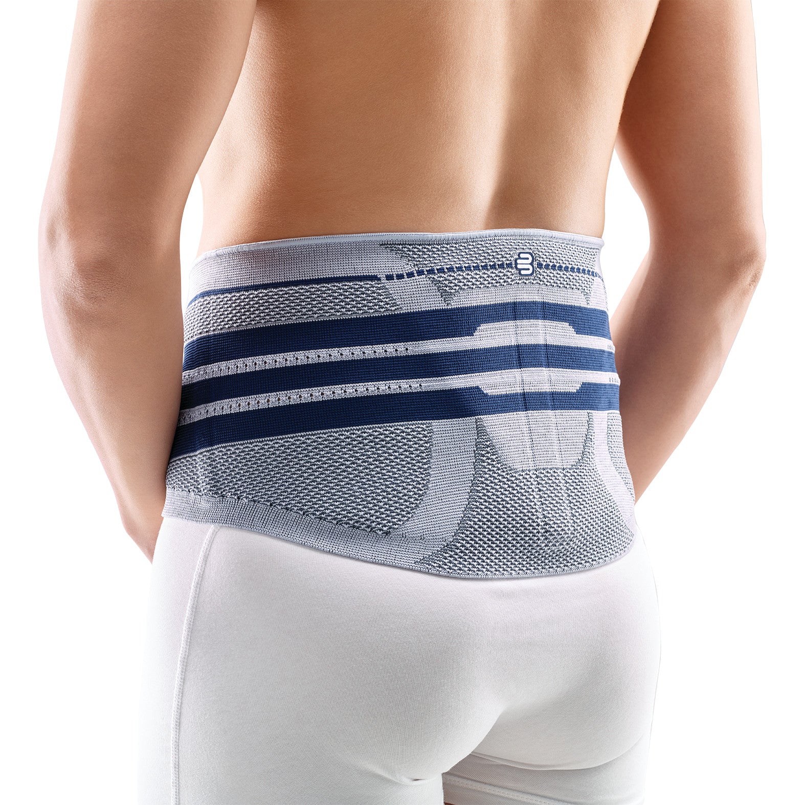 A person wearing a Bauerfeind LumboTrain Back Support. It is gray with navy bands and is worn over white pants.