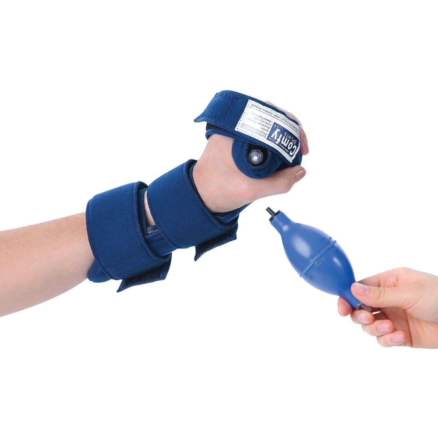 A hand wears the Comfy Splints Adult Hand Air Orthosis, a blue brace with adjustable straps. A hand holds a blue inflating pump.