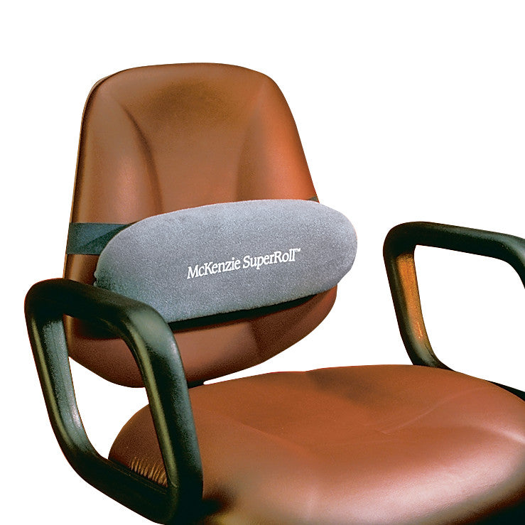 The Original McKenzie SuperRoll Lumbar Support is attached to a brown office chair, providing ergonomic back support.