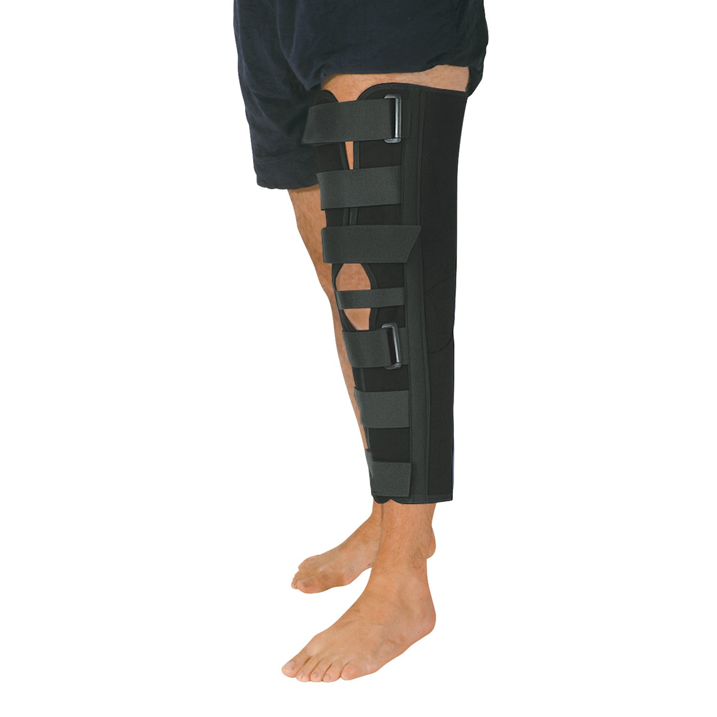 A person wears an Economy Knee Immobilizer on their right leg. It features multiple straps and extends from mid-thigh to ankle.