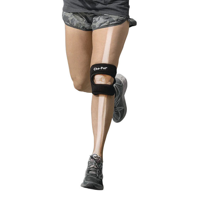 A person wearing the Cho-Pat Dual-Action Knee Strap while running. The strap is black and positioned below the knee.