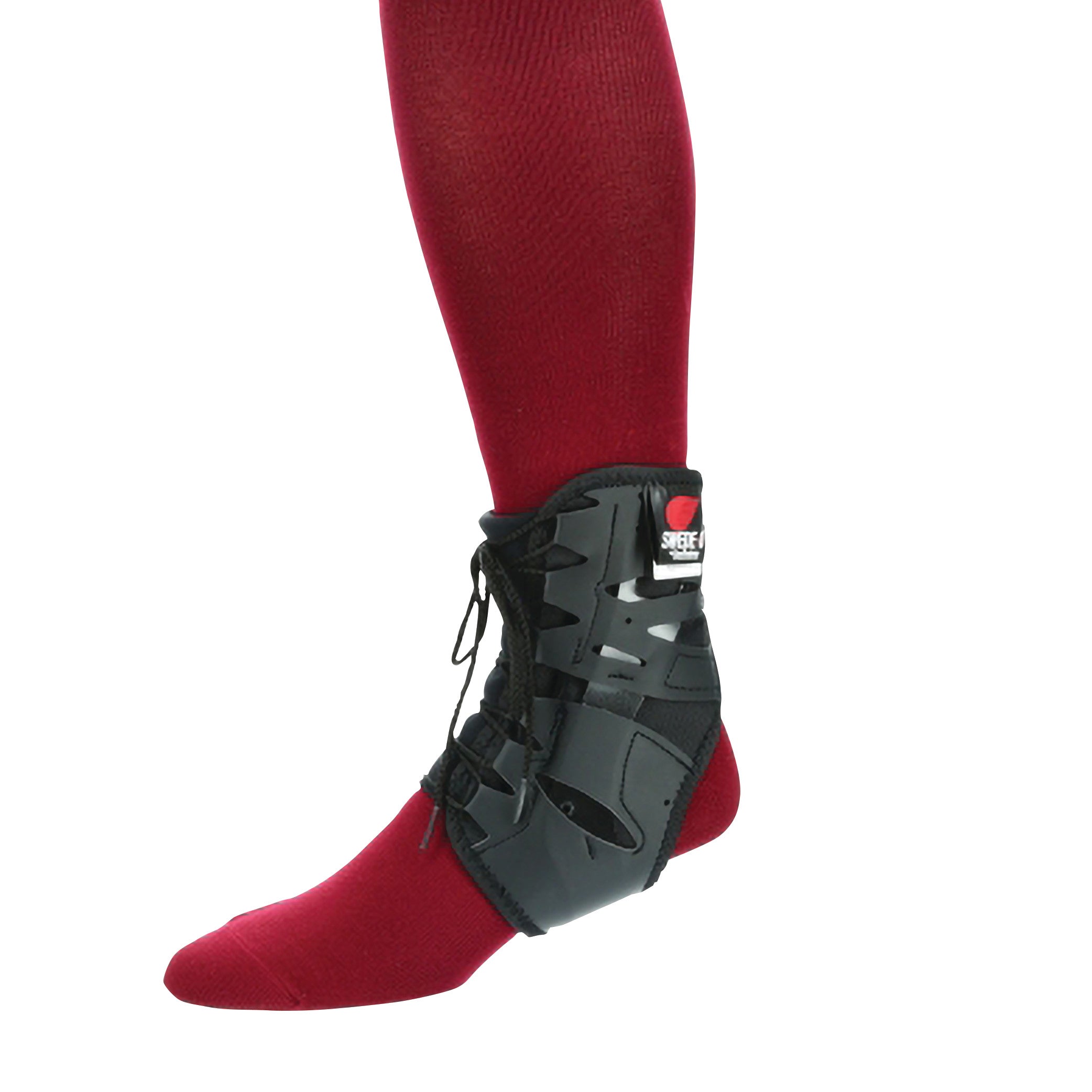 A person wears a Swede-O Tarsal-Lok Ankle Brace over a red sock. The black brace features laces and adjustable straps.