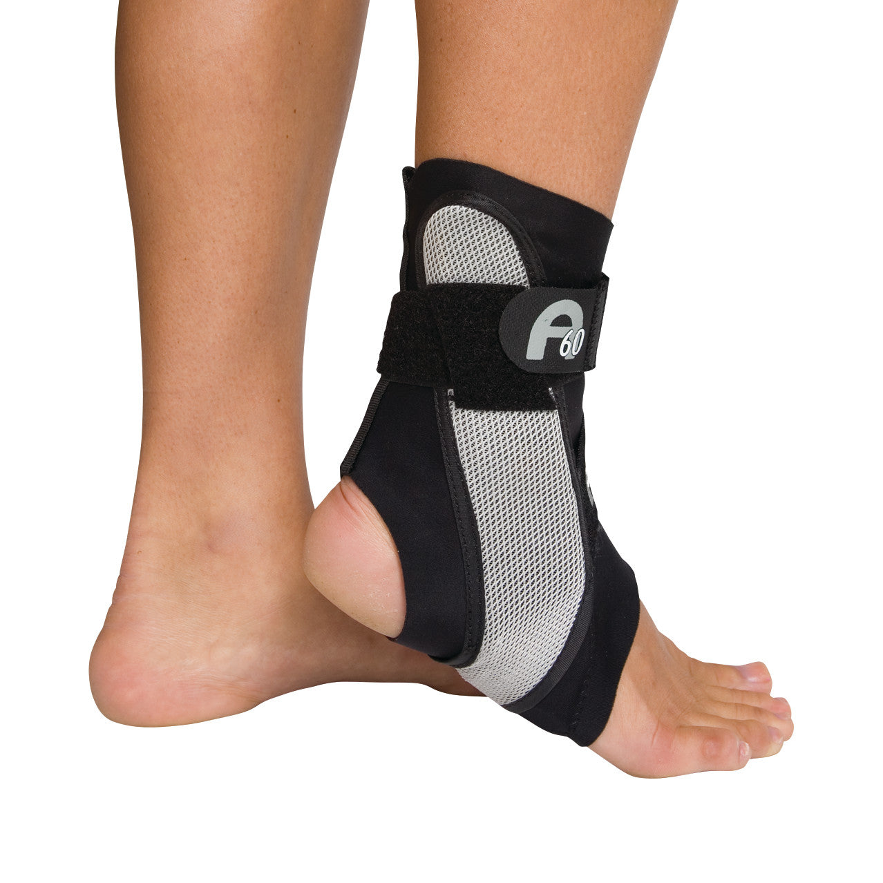 A foot wearing the Aircast A60 Ankle Support, featuring a black and gray design with a strap around the ankle for stability.