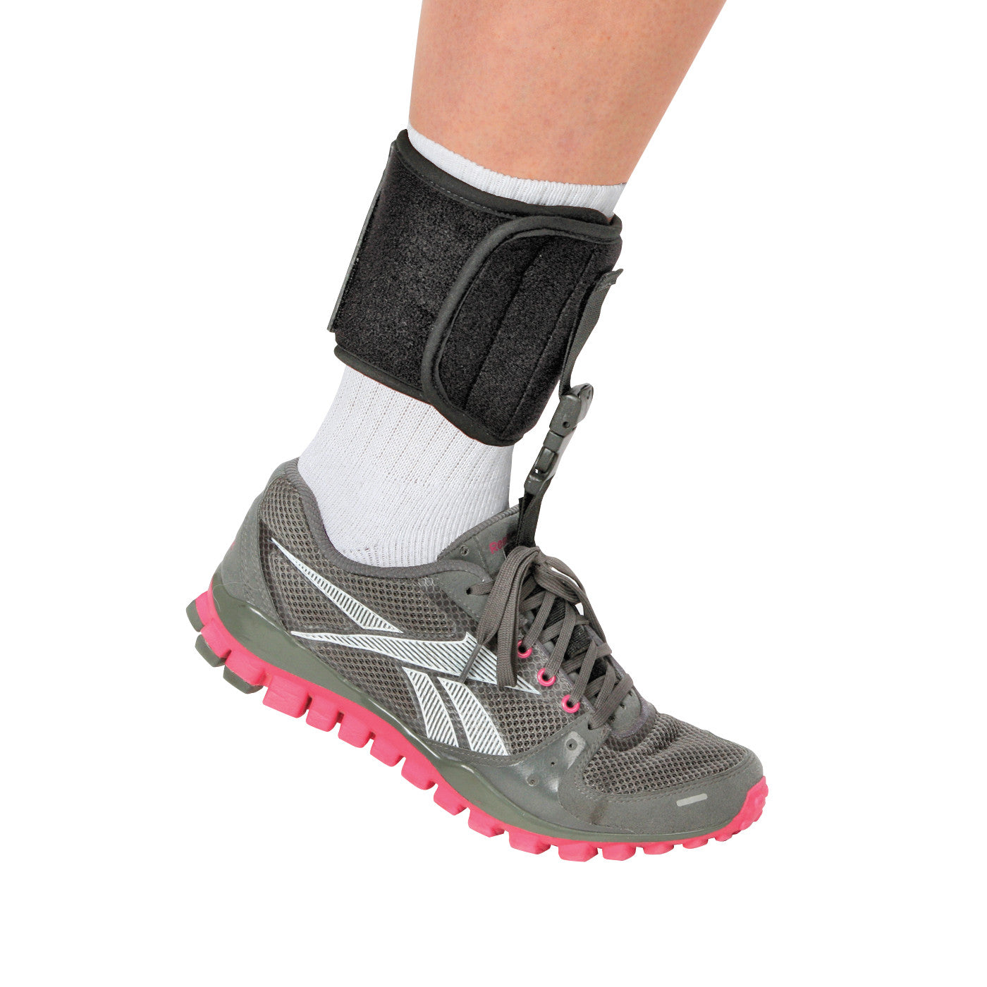 A person wearing the AliMed FREEDOM Adjustable Footdrop Brace attached to a gray and pink sneaker, with a white sock.